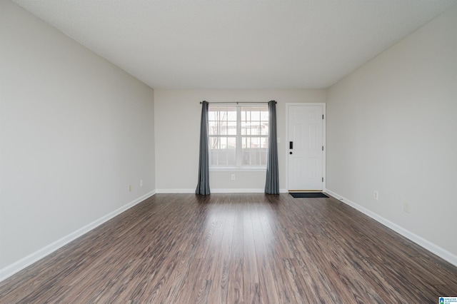 spare room with dark hardwood / wood-style floors