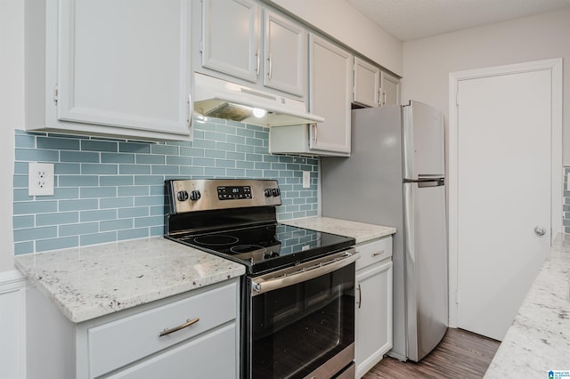 kitchen featuring light stone countertops, light hardwood / wood-style flooring, backsplash, and stainless steel range with electric stovetop