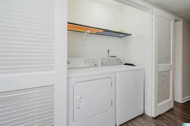 laundry area with dark hardwood / wood-style flooring, separate washer and dryer, and a textured ceiling