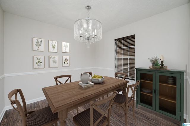 dining room featuring dark wood-type flooring and an inviting chandelier