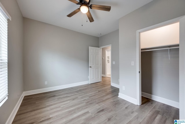 unfurnished bedroom featuring a closet, ceiling fan, and light wood-type flooring