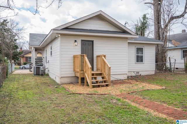 back of property featuring a yard