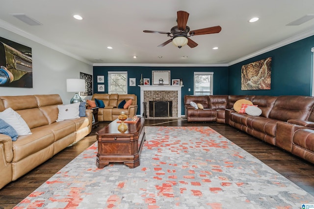 living room with dark wood-type flooring, ceiling fan, and ornamental molding