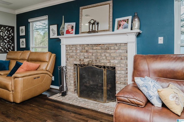 living room with ornamental molding, a brick fireplace, and dark hardwood / wood-style flooring