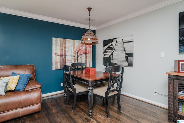 dining area with dark wood-type flooring and ornamental molding