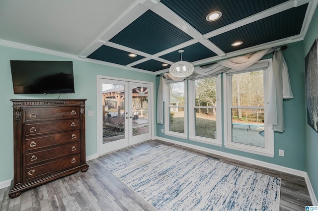 interior space with french doors, ornamental molding, wood-type flooring, and coffered ceiling