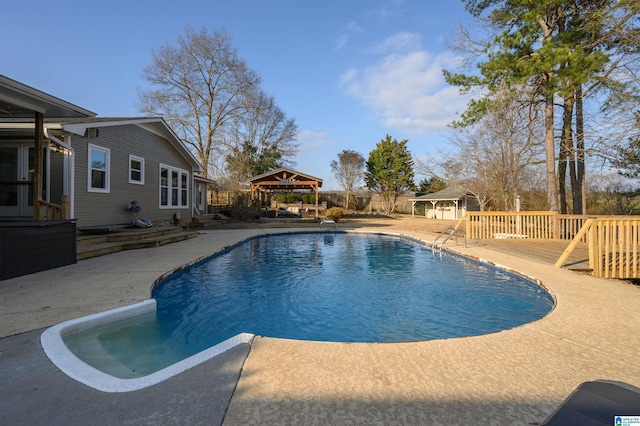 view of pool featuring a gazebo, an outdoor structure, and a patio