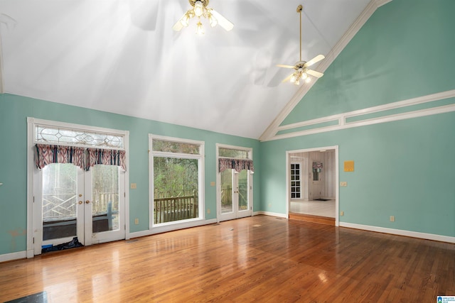 unfurnished living room with french doors, ceiling fan, wood-type flooring, and high vaulted ceiling