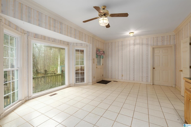 spare room with light tile patterned floors, crown molding, plenty of natural light, and ceiling fan