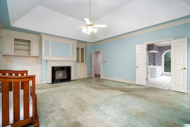 unfurnished living room with light carpet, ornamental molding, and a premium fireplace