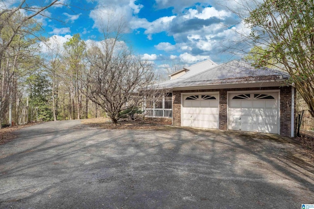 view of property exterior with a porch and a garage