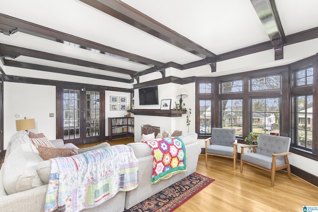 living room with beam ceiling, french doors, and light wood-type flooring