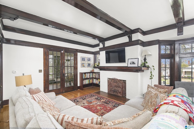 living room with hardwood / wood-style floors, beam ceiling, and french doors