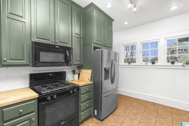 kitchen with light tile patterned flooring, butcher block countertops, tasteful backsplash, green cabinets, and black appliances