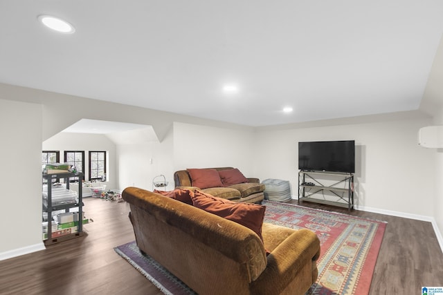 living room with lofted ceiling and dark hardwood / wood-style floors