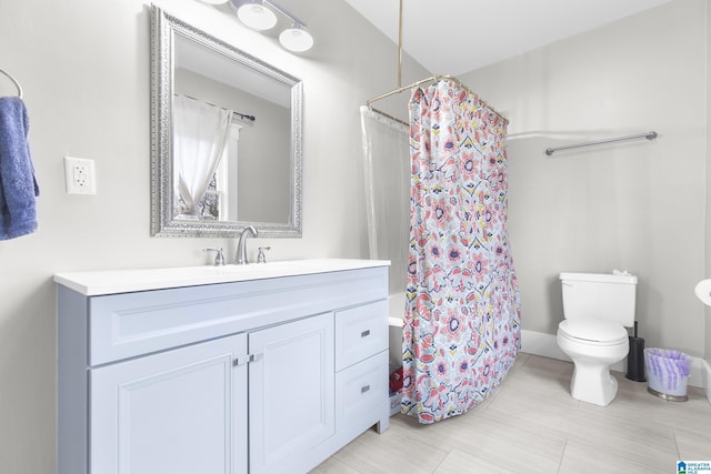 bathroom with walk in shower, vanity, and toilet