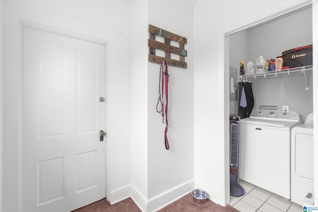 washroom with light tile patterned flooring and washing machine and dryer