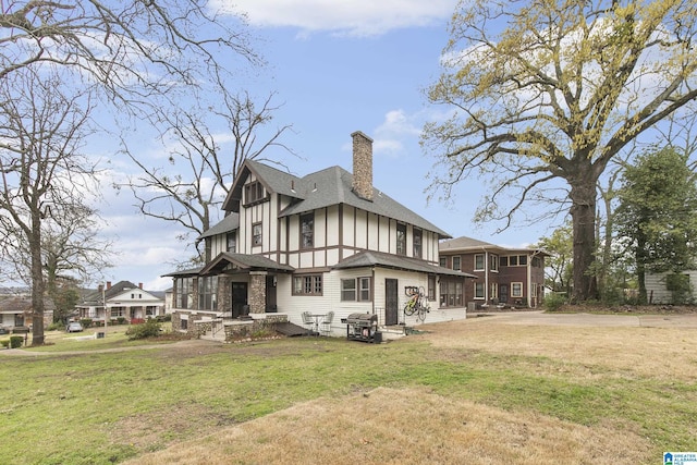 back of property with a yard and a sunroom