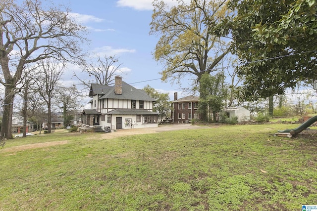 rear view of property with a patio area and a lawn