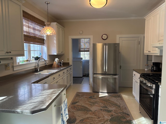 kitchen with sink, crown molding, pendant lighting, stainless steel appliances, and washer / clothes dryer