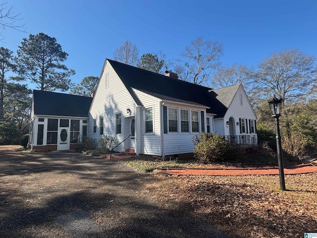 view of side of home featuring a sunroom