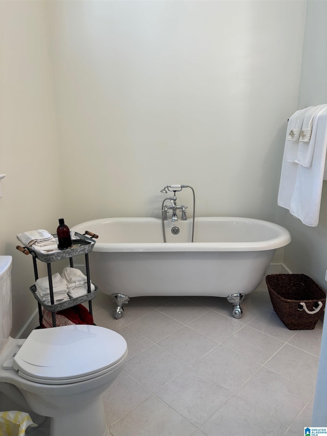 bathroom featuring tile patterned floors, toilet, and a bathing tub