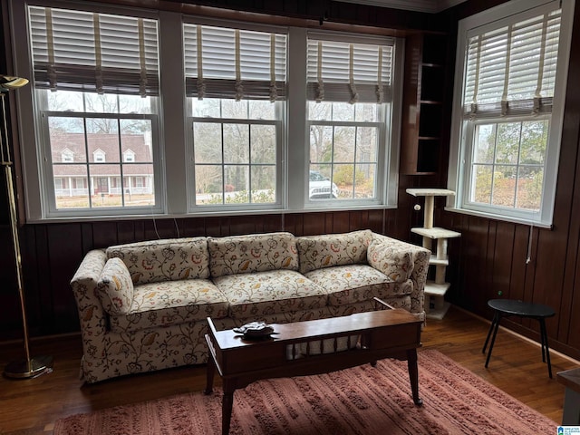 living area with hardwood / wood-style floors and wood walls