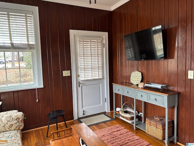 entrance foyer featuring wood-type flooring and wooden walls