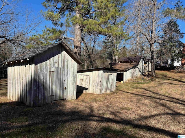 view of outbuilding featuring a lawn