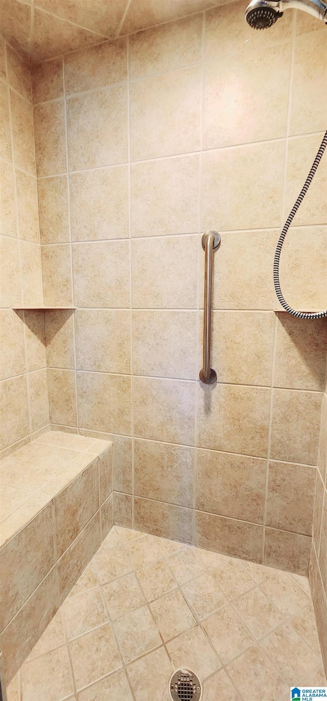 bathroom with a tile shower