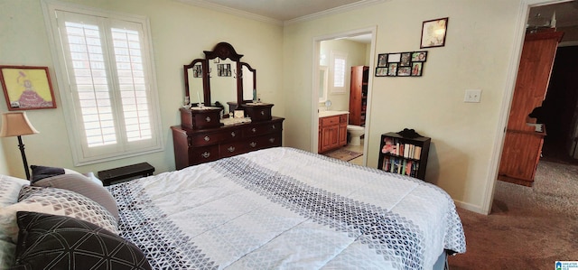 carpeted bedroom with connected bathroom and ornamental molding