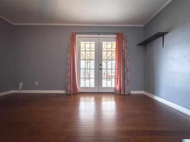 spare room featuring hardwood / wood-style flooring, crown molding, and french doors