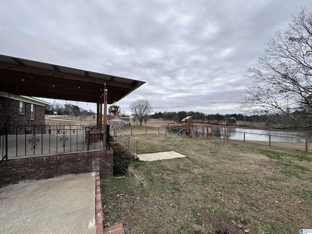 view of yard featuring a playground and a water view