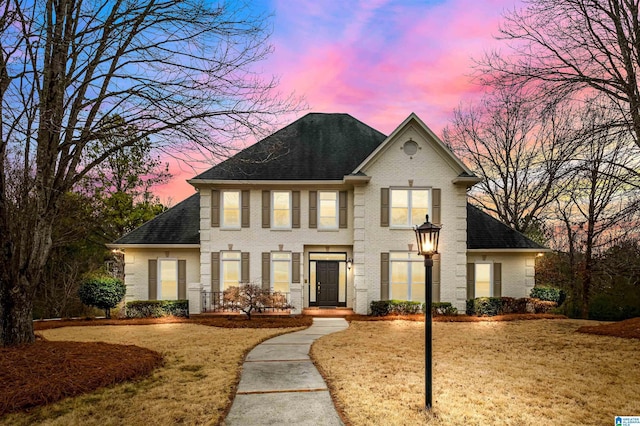 colonial inspired home featuring a lawn