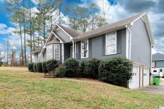 view of front of property with a garage and a front lawn