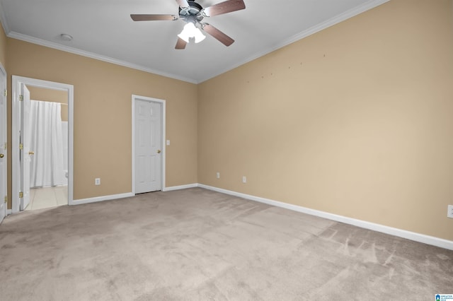 spare room with ceiling fan, ornamental molding, and light carpet