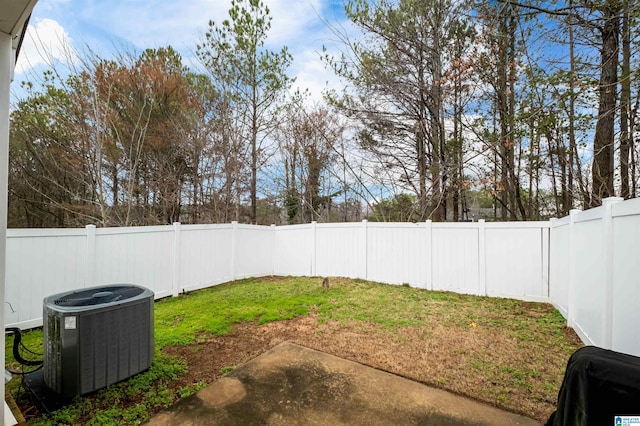 view of yard featuring central AC unit and a patio area