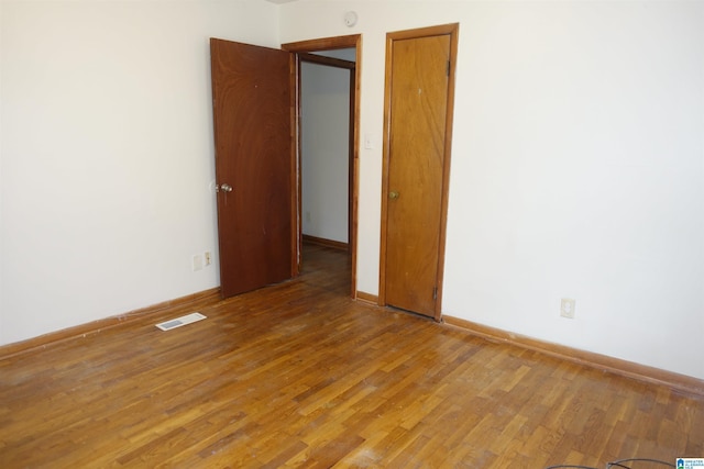 empty room with wood-type flooring