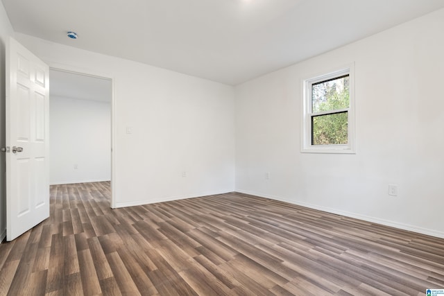 empty room featuring dark wood-type flooring