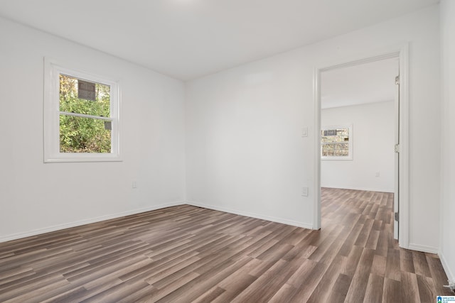 spare room with dark hardwood / wood-style flooring