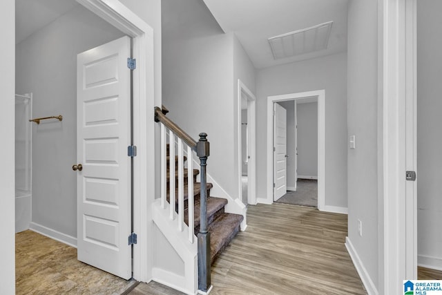 stairway with hardwood / wood-style flooring