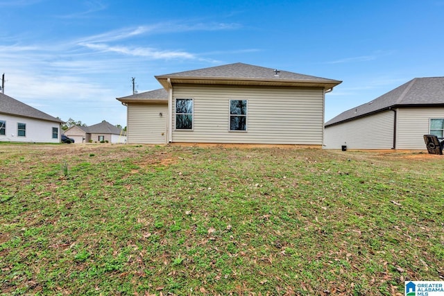 rear view of property with a lawn