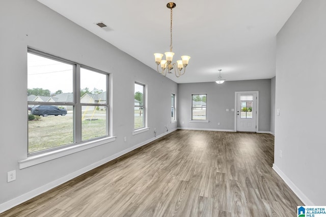 interior space featuring hardwood / wood-style flooring and a chandelier