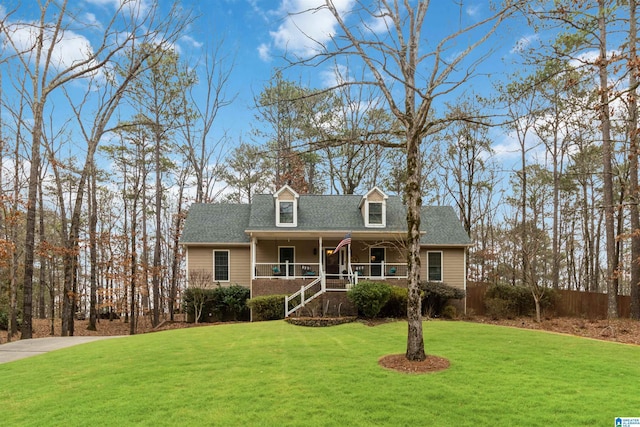 cape cod-style house featuring a porch and a front lawn