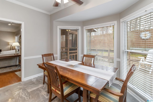 dining area featuring crown molding and ceiling fan