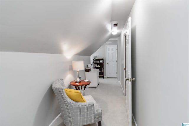 living area with vaulted ceiling and light carpet