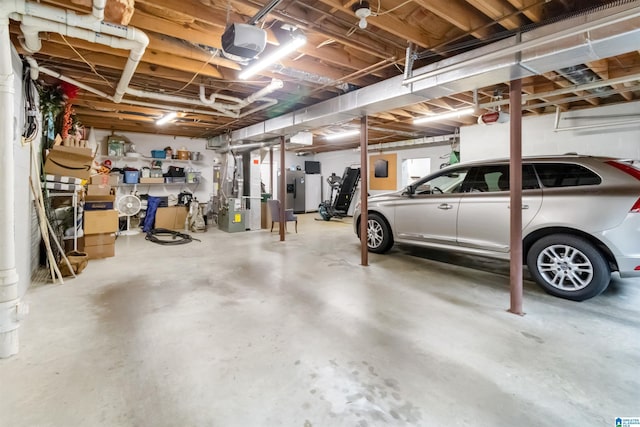 garage featuring a garage door opener and heating unit