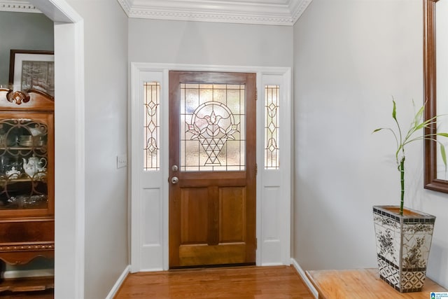 entrance foyer with hardwood / wood-style flooring and ornamental molding