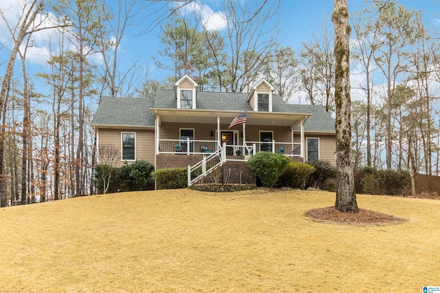 cape cod house featuring a front lawn and covered porch