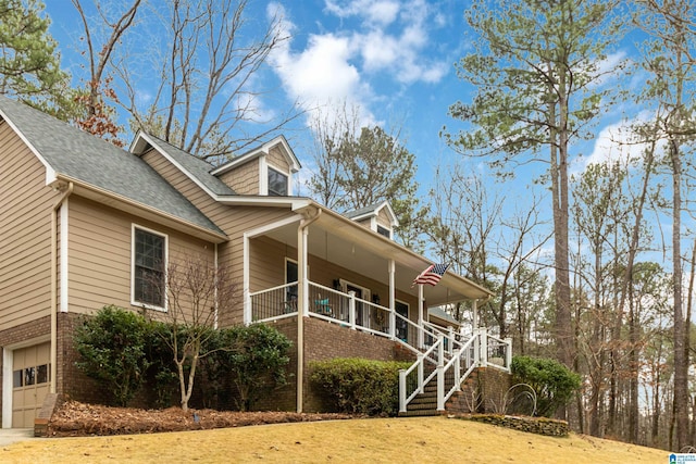 view of side of home with a porch and a garage